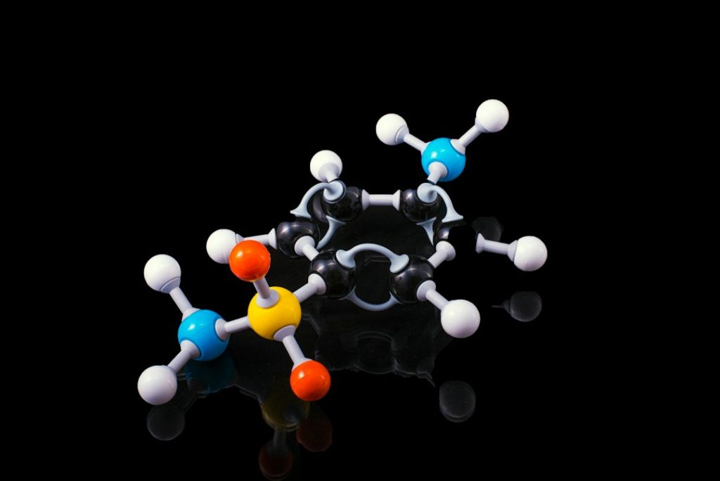 A model of molecular structures representing peptide compounds against a black background.